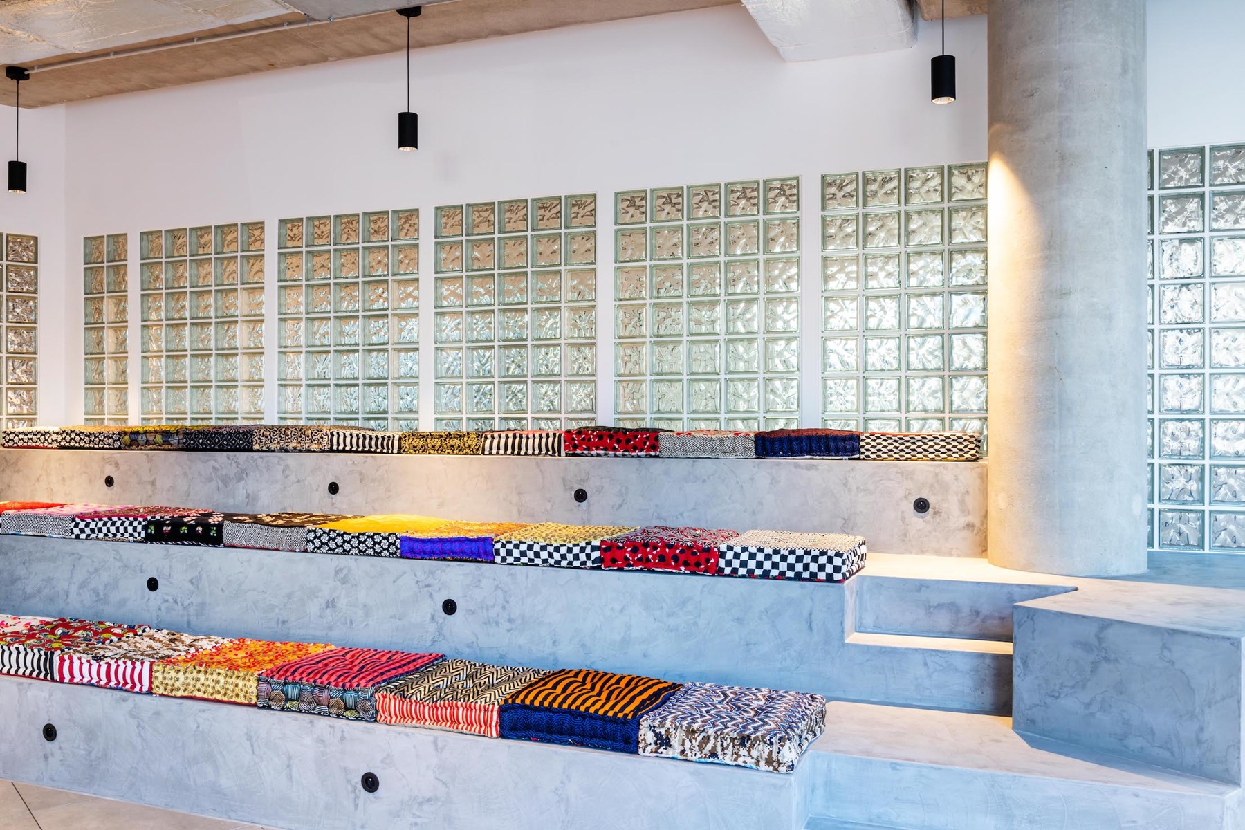 Credits - Marthe Hoet © Seating with colourful, domestic-inspired cushions provides a place for collaboration